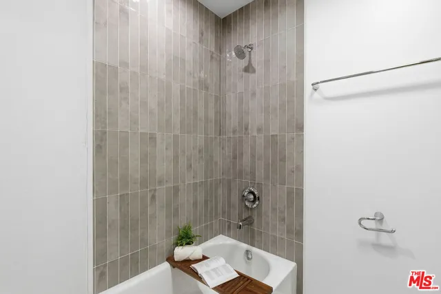 a bathroom with a shower and a sink