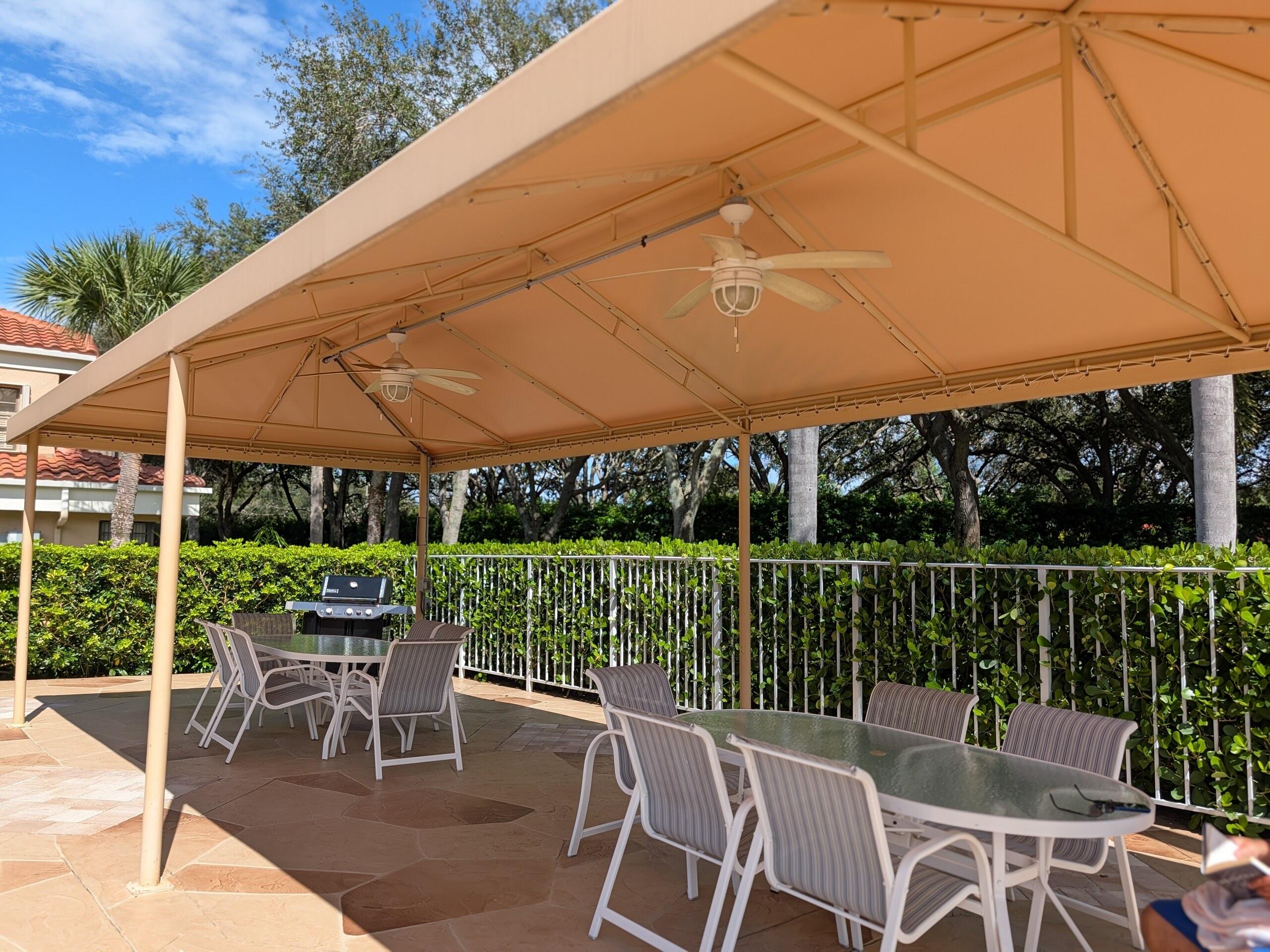 17372 Boca Club Boulevard, Unit 405 Boca Raton, FL 33487 - Photo 64 of 74 a patio with wooden floor a yard tables and chairs