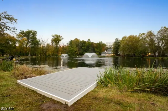 a dining room with furniture a chandelier and wooden floor