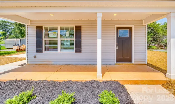 a view of a house with a backyard and a tub