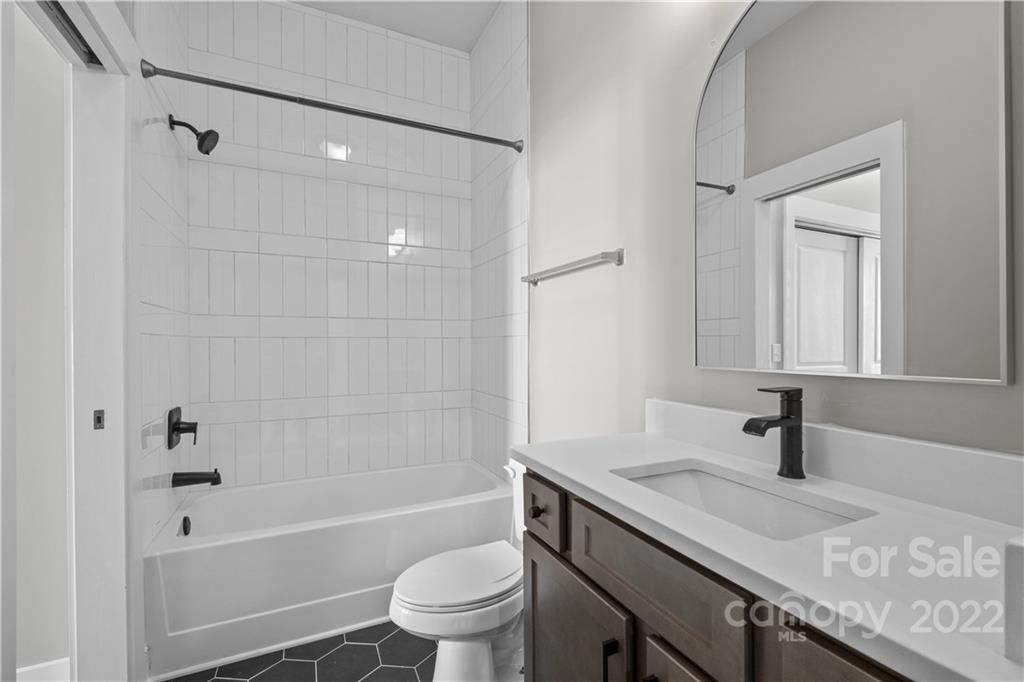3279 Noda Boulevard Charlotte, NC 28205 - Photo 12 of 20 a bathroom with a granite countertop sink a toilet and shower