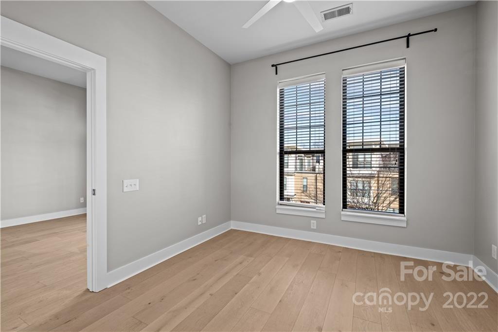 3279 Noda Boulevard Charlotte, NC 28205 - Photo 16 of 20 an empty room with wooden floor and windows