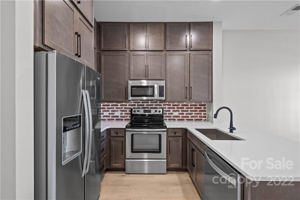 3279 Noda Boulevard Charlotte, NC 28205 - Photo 2 of 20 a kitchen with stainless steel appliances granite countertop a refrigerator and a stove top oven