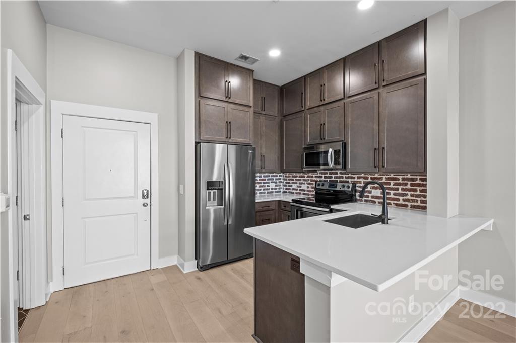 3279 Noda Boulevard Charlotte, NC 28205 - Photo 3 of 20 a kitchen with a refrigerator a sink and a refrigerator