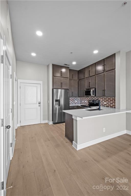 3279 Noda Boulevard Charlotte, NC 28205 - Photo 4 of 20 a large kitchen with kitchen island a sink stainless steel appliances and cabinets