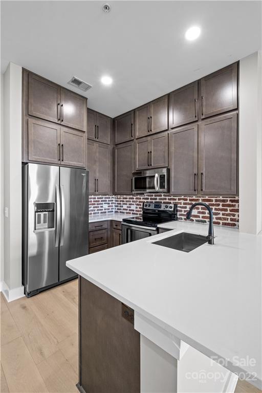 3279 Noda Boulevard Charlotte, NC 28205 - Photo 5 of 20 a kitchen with stainless steel appliances a refrigerator and a sink