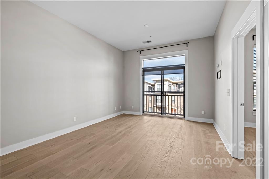 3279 Noda Boulevard Charlotte, NC 28205 - Photo 10 of 20 wooden floor in an empty room with a window