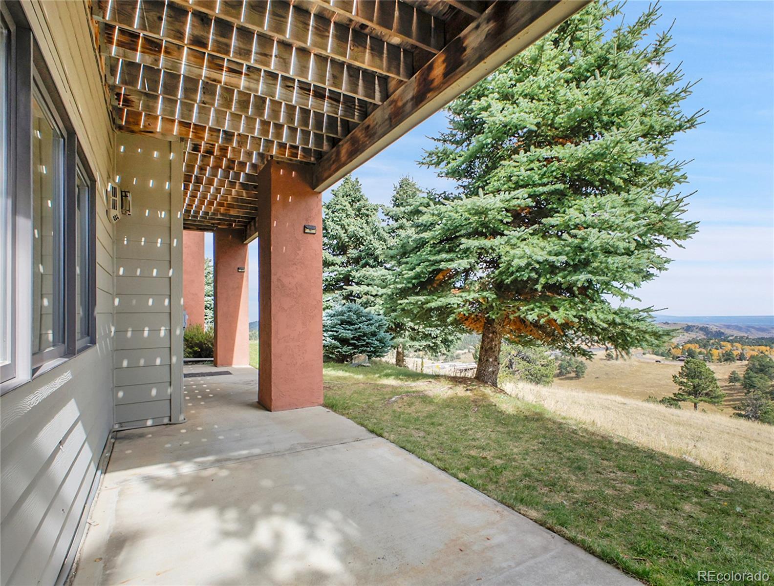 568 Ridgeside Drive Golden, CO 80401 - Photo 32 of 48 a backyard of a house with a garden and plants