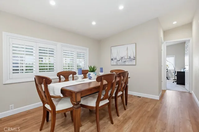 a large kitchen with stainless steel appliances kitchen island granite countertop a large counter top a sink dishwasher and a stove with wooden floors