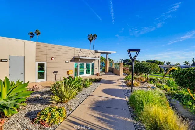 a living room with furniture a flat screen tv and kitchen view