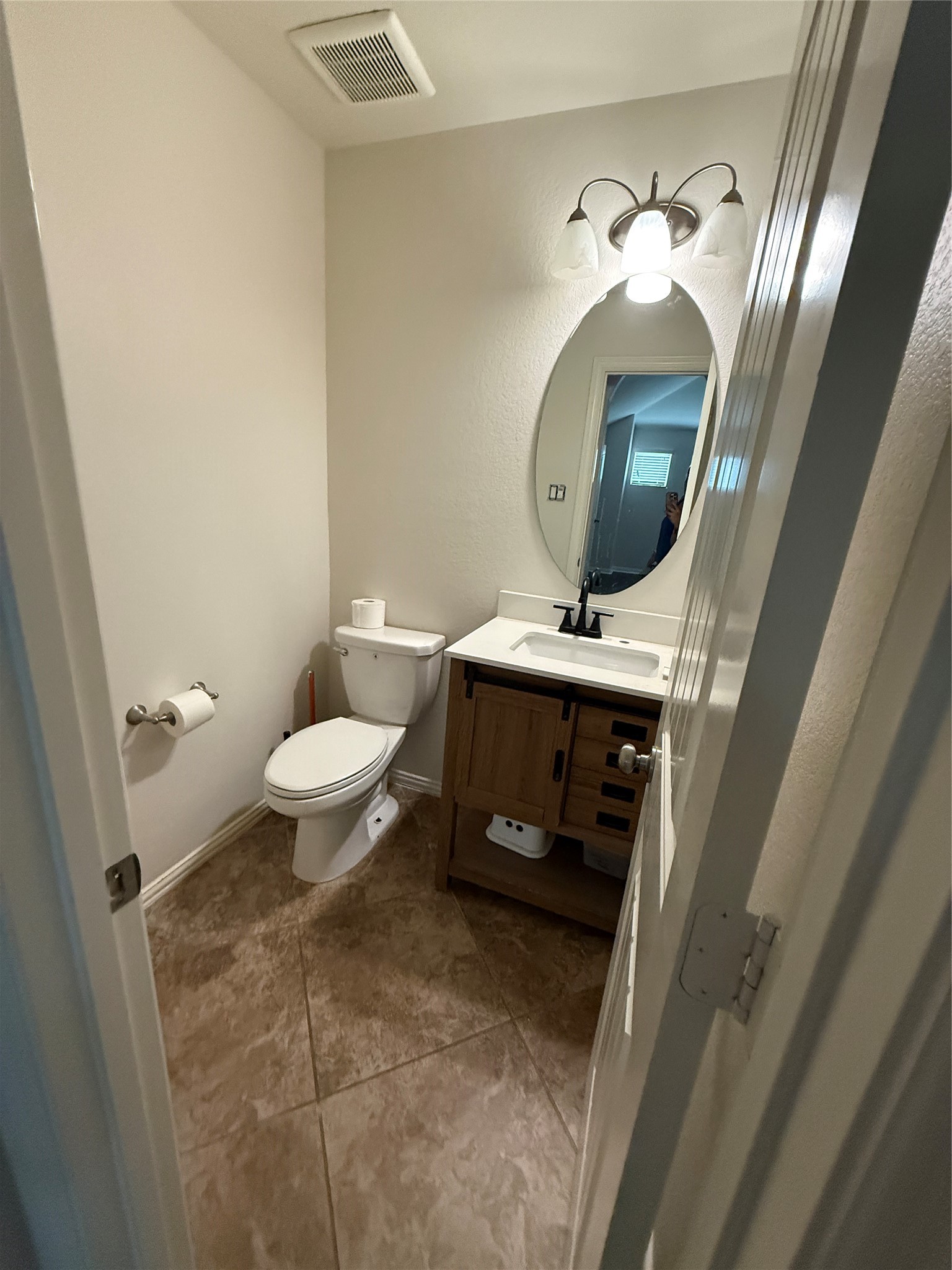 20206 Lago Bluff Loop Cypress, TX 77433 - Photo 16 of 16 a bathroom with a toilet sink and mirror