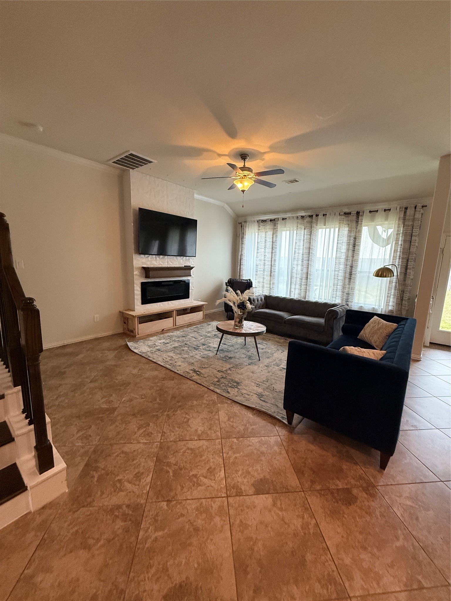 20206 Lago Bluff Loop Cypress, TX 77433 - Photo 3 of 16 a living room with furniture a flat screen tv and kitchen view