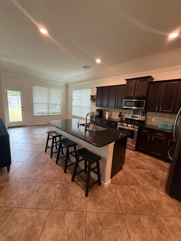 20206 Lago Bluff Loop Cypress, TX 77433 - Photo 4 of 16 a kitchen with granite countertop a stove a sink a counter space and cabinets