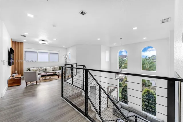 a view of living room and kitchen with furniture wooden floor and windows