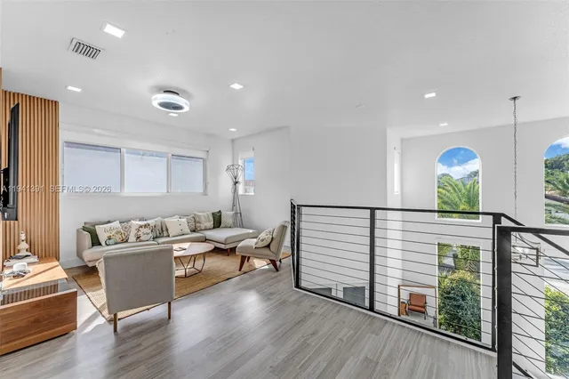 a living room with furniture and wooden floor