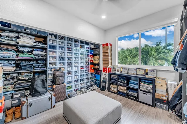 a room with furniture a rug and a book shelf