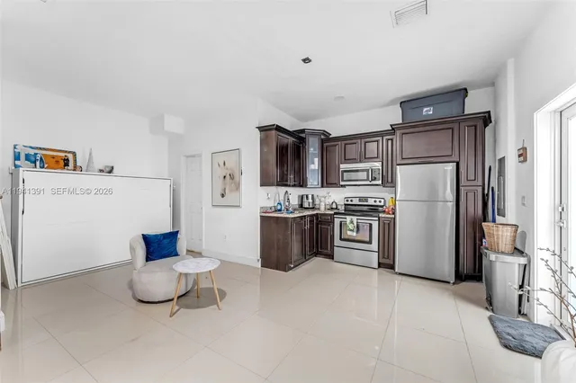 a kitchen with stainless steel appliances a refrigerator and a stove