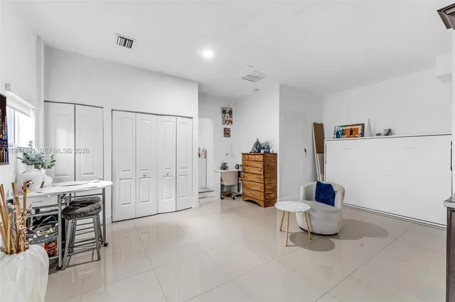 a living room with furniture and a book shelf