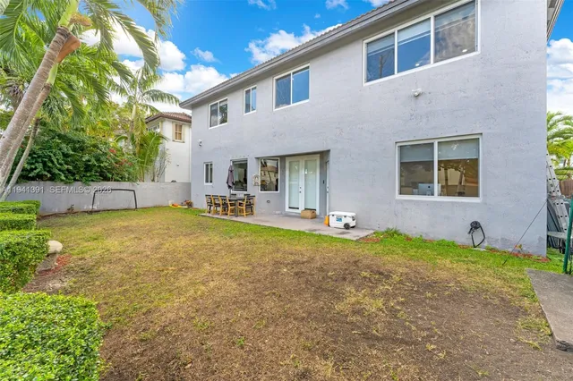 a house view with swimming pool in front of it