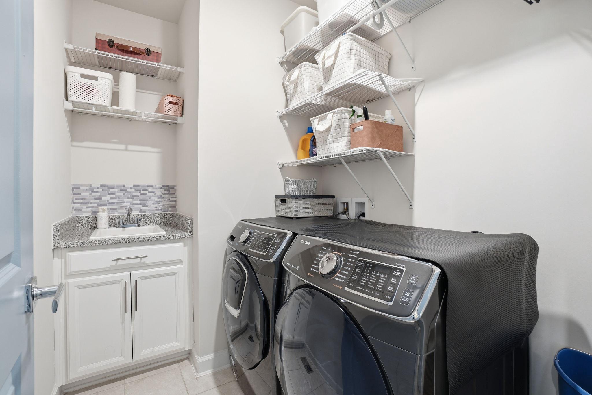 12916 Sunrise Ridge Alley, Unit 63 Herndon, VA 20171 - Photo 20 of 71 Modern laundry room with sink and appliances.