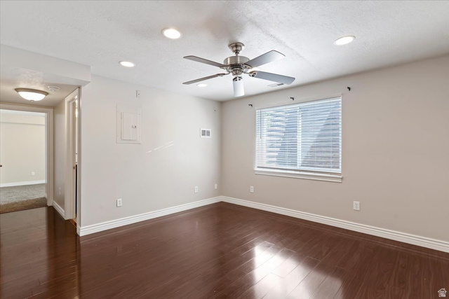 2350 South Highway 89, Unit 4 Perry, UT 84302 - Photo 8 of 30 Spare room featuring dark wood-style floors, electric panel, ceiling fan, a textured ceiling, and recessed lighting