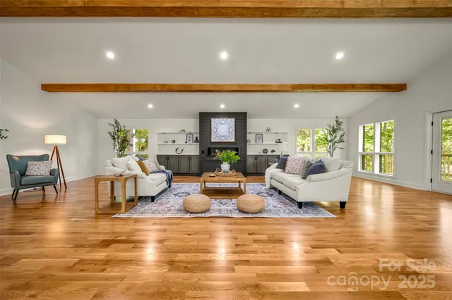 a living room with fireplace furniture and a wooden floor