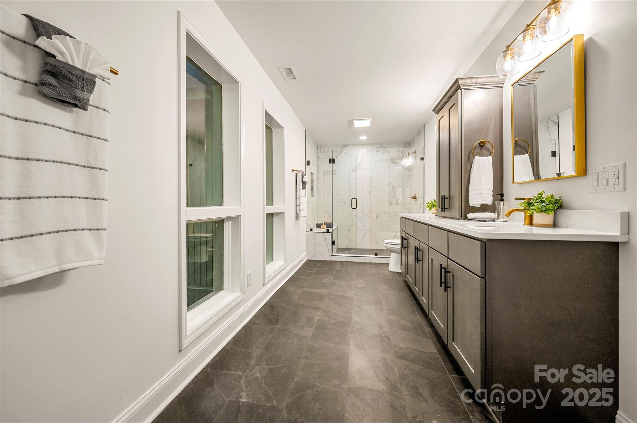160 Lasae Lane Tryon, NC 28782 - Photo 16 of 48 a bathroom with a double vanity sink toilet and shower
