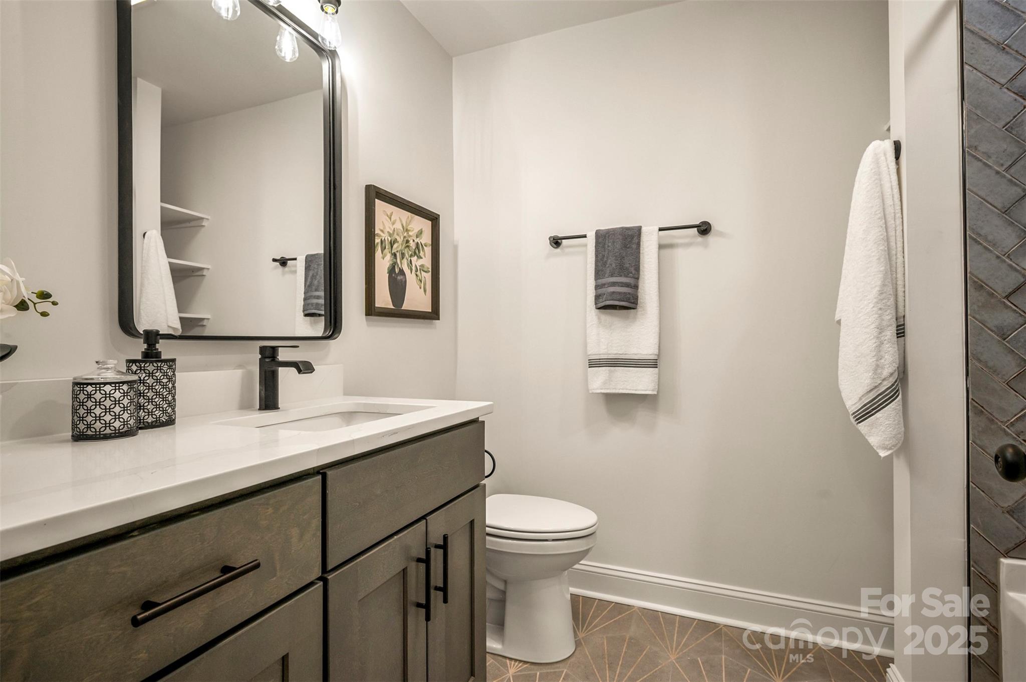 160 Lasae Lane Tryon, NC 28782 - Photo 18 of 48 a bathroom with a granite countertop sink toilet and mirror