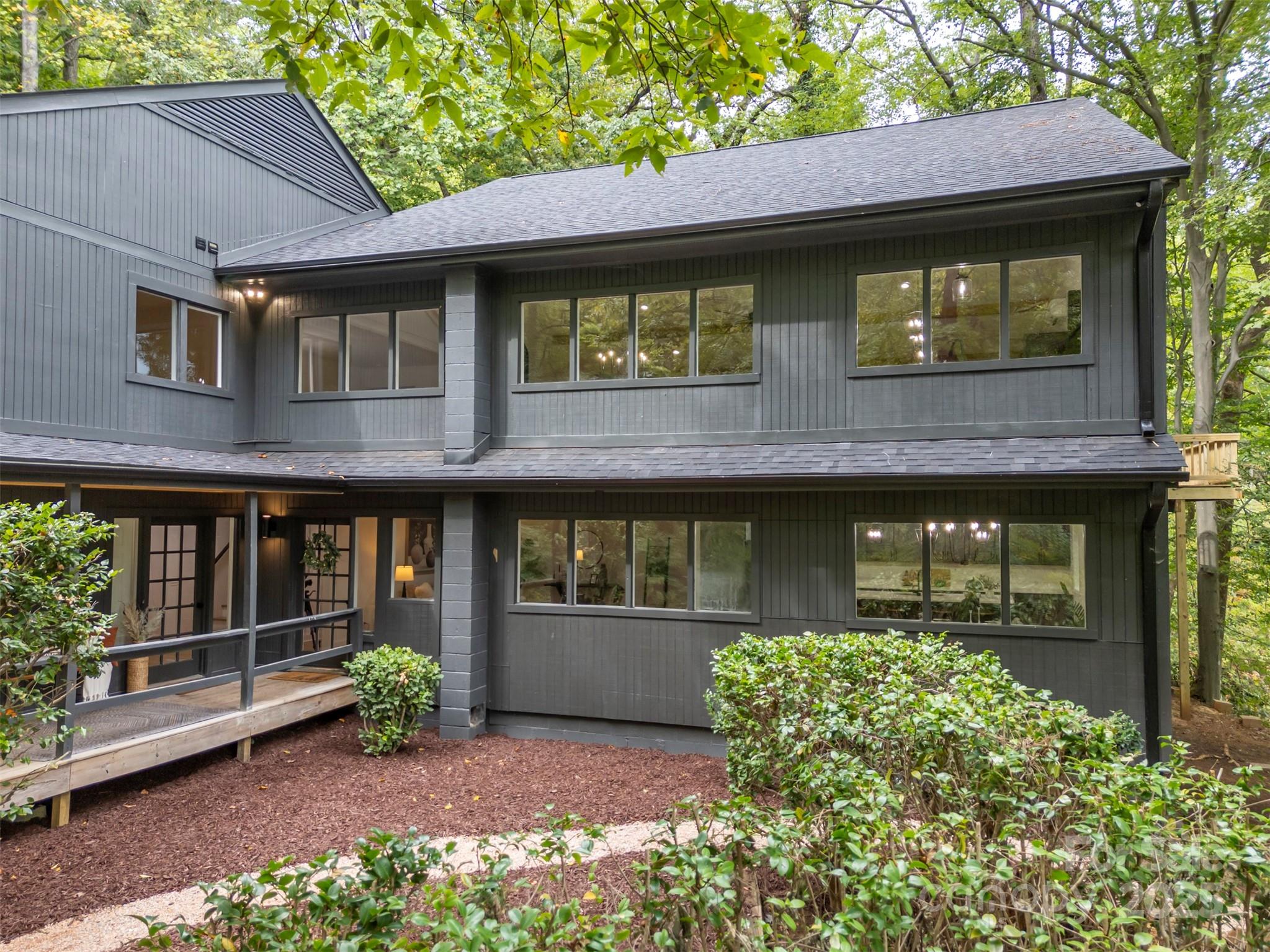 160 Lasae Lane Tryon, NC 28782 - Photo 2 of 48 a front view of a house with a garden