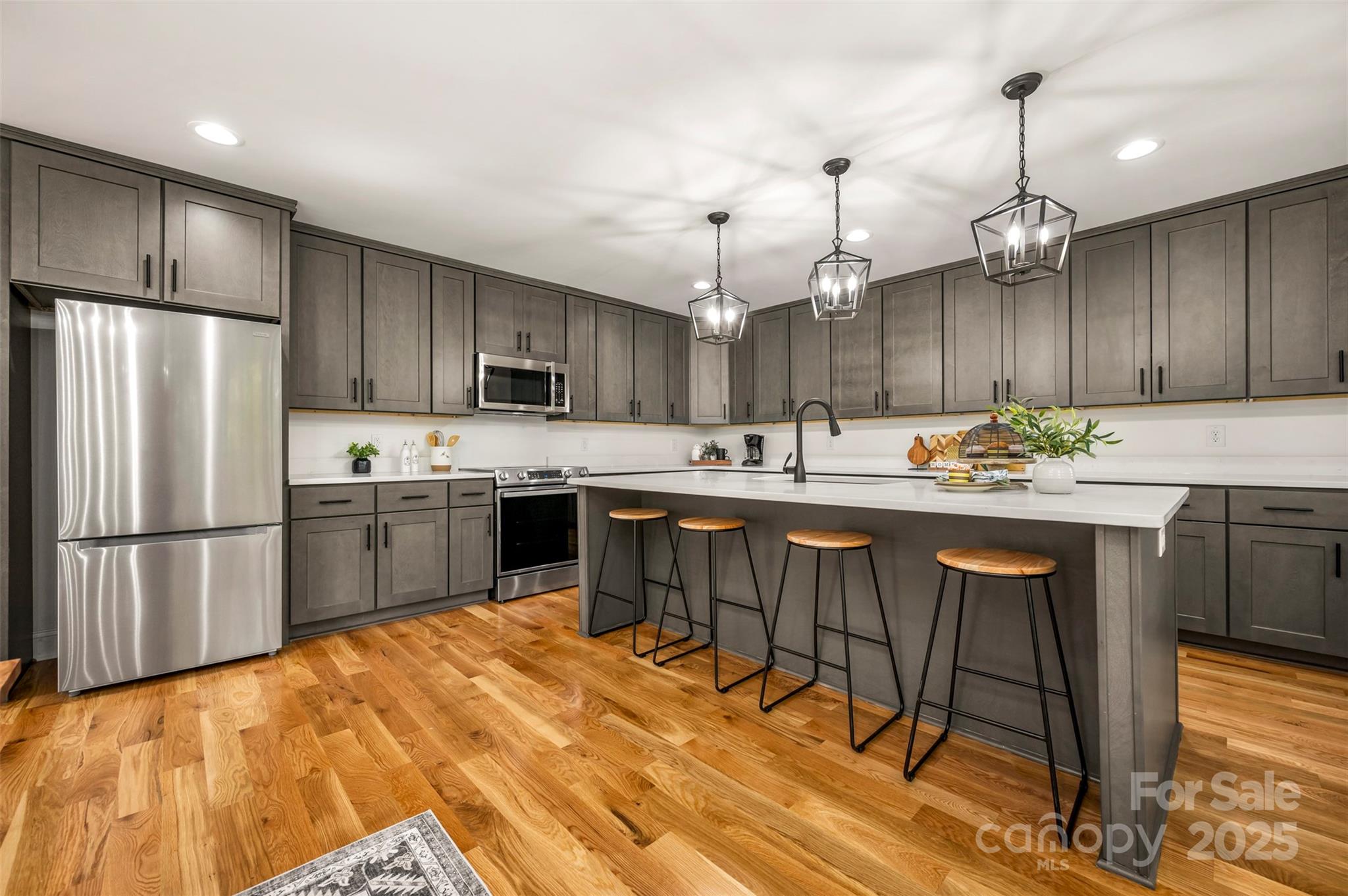160 Lasae Lane Tryon, NC 28782 - Photo 24 of 48 a kitchen with kitchen island a stove a refrigerator a sink and a oven with cabinets