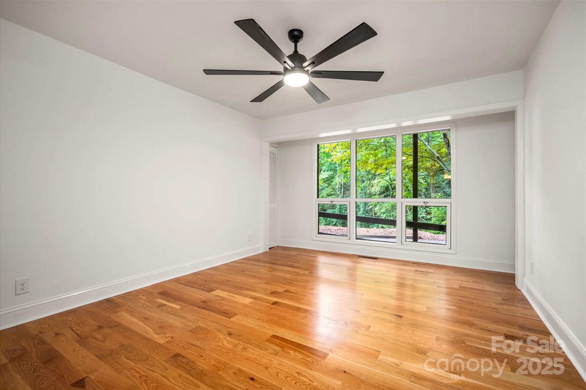 160 Lasae Lane Tryon, NC 28782 - Photo 33 of 48 a view of empty room with wooden floor and ceiling fan