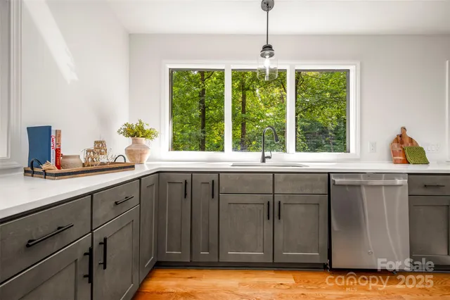 a kitchen with a sink and large window