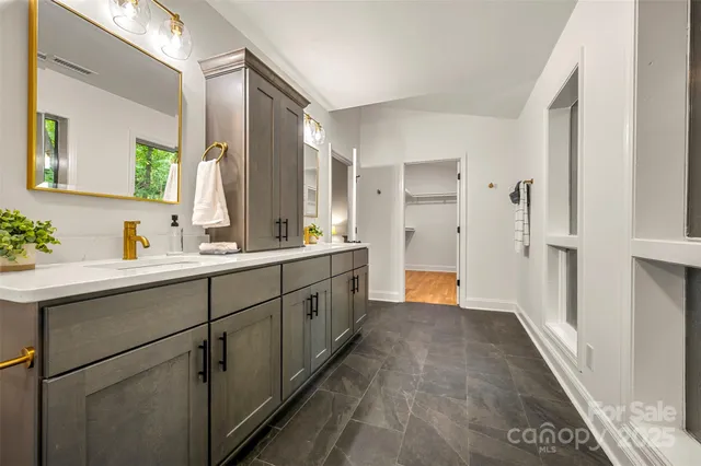a bathroom with a double vanity sink and mirror