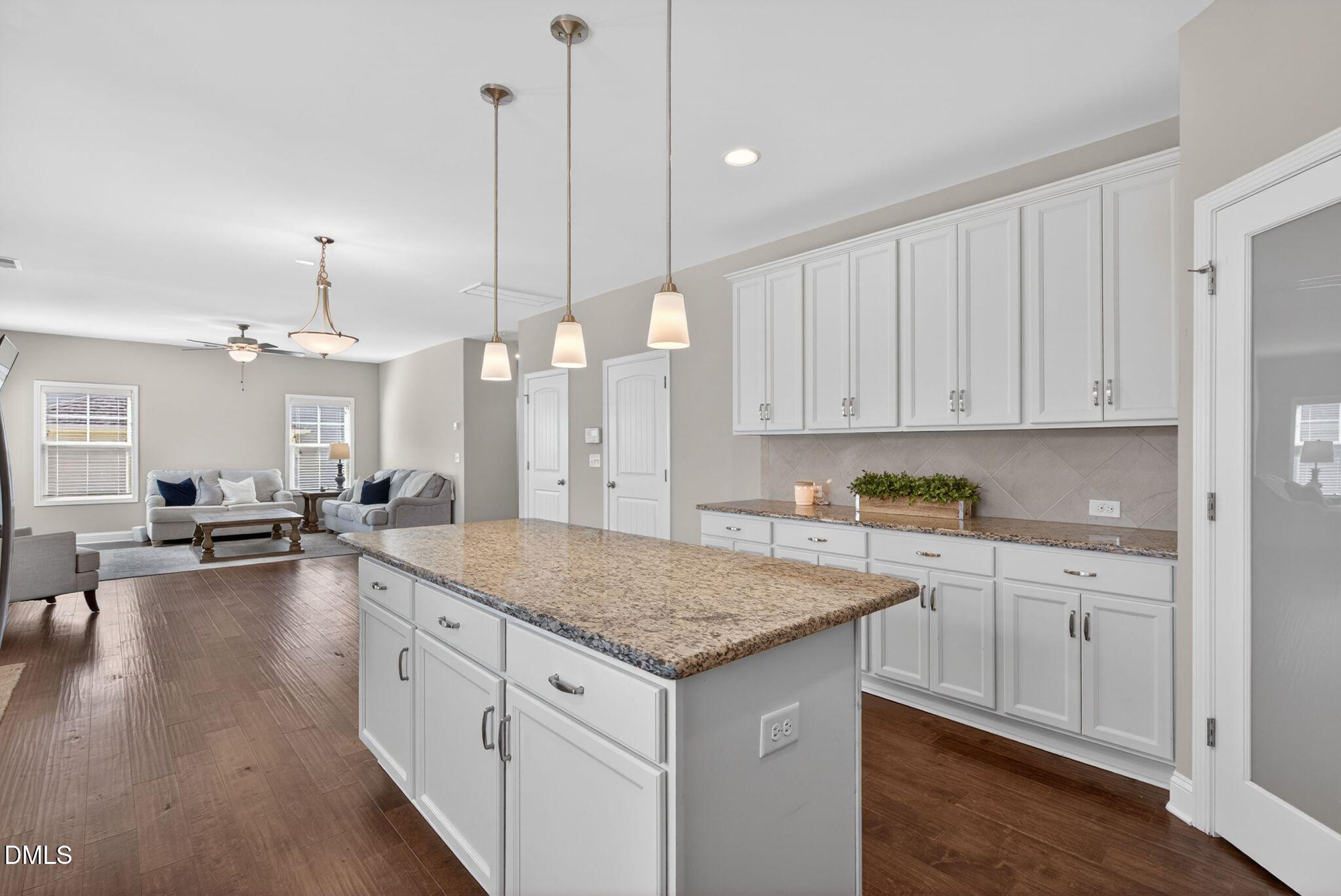 164 East Ravano Drive Clayton, NC 27527 - Photo 15 of 30 a kitchen that has a lot of cabinets in it and wooden floors