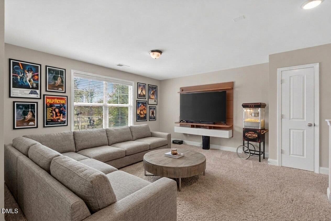 164 East Ravano Drive Clayton, NC 27527 - Photo 16 of 30 a living room with furniture and a flat screen tv