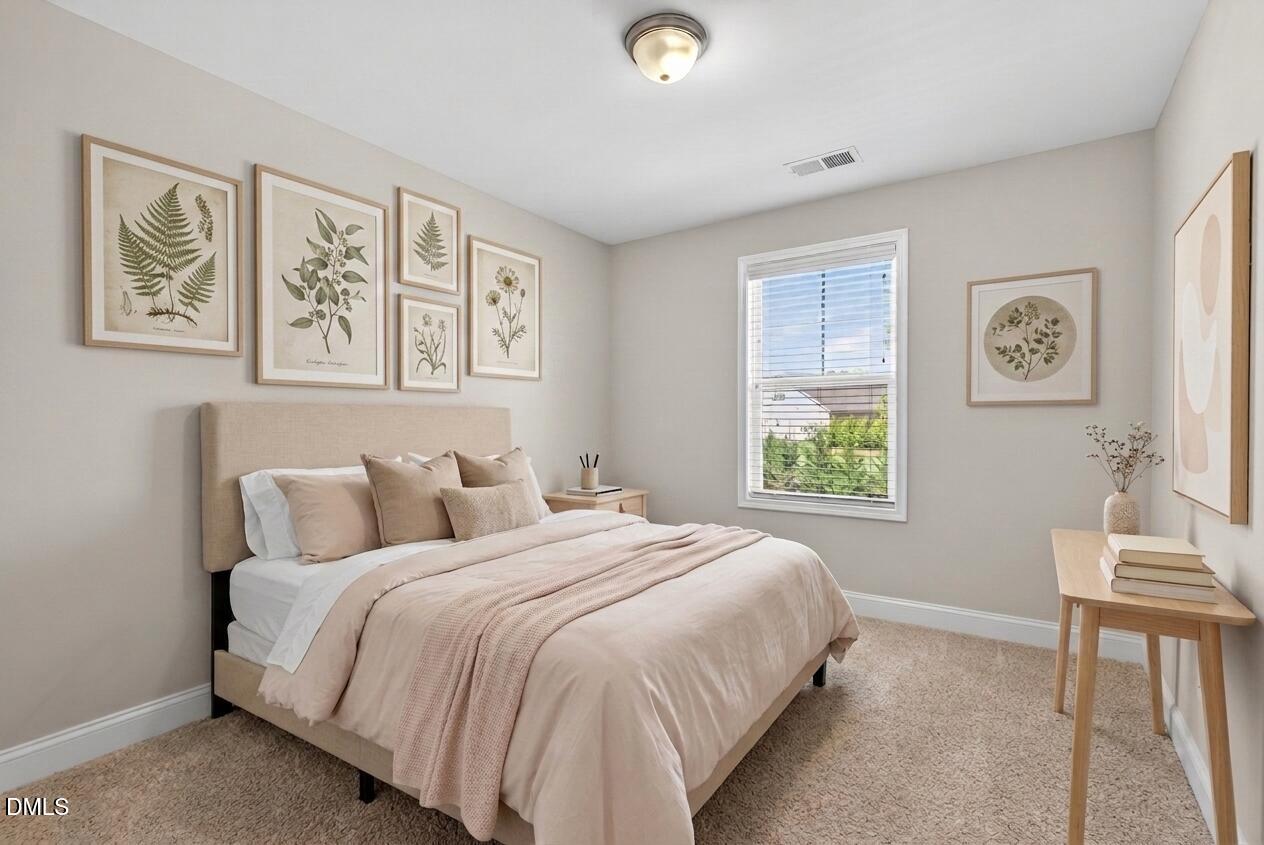 164 East Ravano Drive Clayton, NC 27527 - Photo 17 of 30 a bedroom with a bed and a painting on the wall