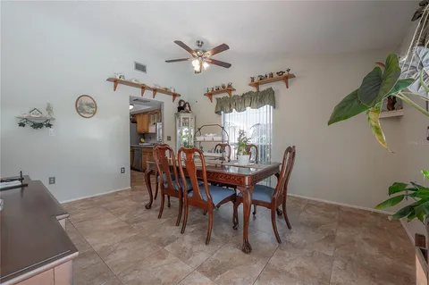 a view of a dining room with furniture and a chandelier