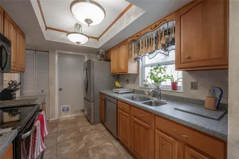 a kitchen with stainless steel appliances granite countertop a sink and cabinets