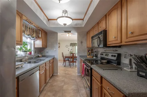 a kitchen with stainless steel appliances granite countertop a sink stove and cabinets