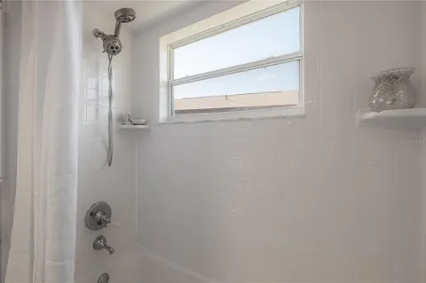 a bedroom with bed and window