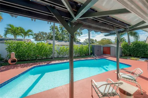 a view of a backyard with sitting area