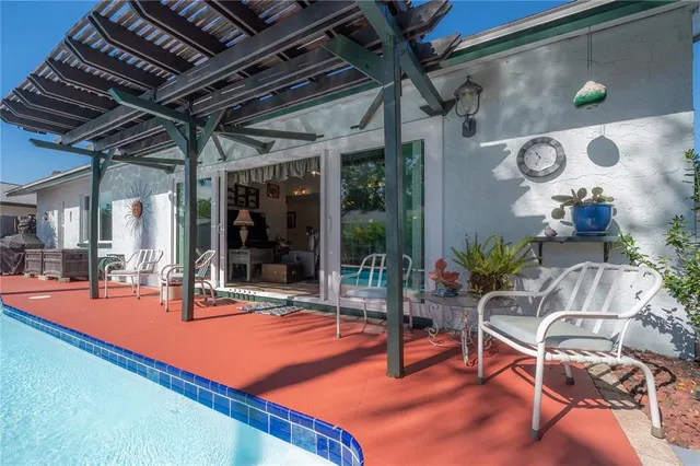 a view of a backyard with plants and a patio