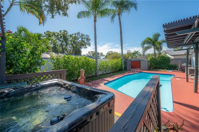a view of a house with swimming pool and furniture