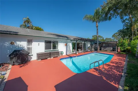 a view of a backyard with swimming pool