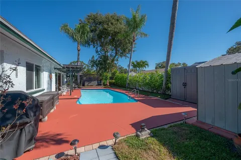 an outdoor space with swimming pool and furniture