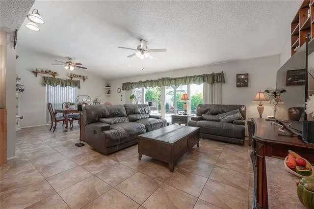 a living room with furniture and kitchen view
