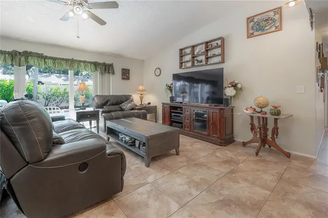 a view of a livingroom with furniture and a ceiling fan