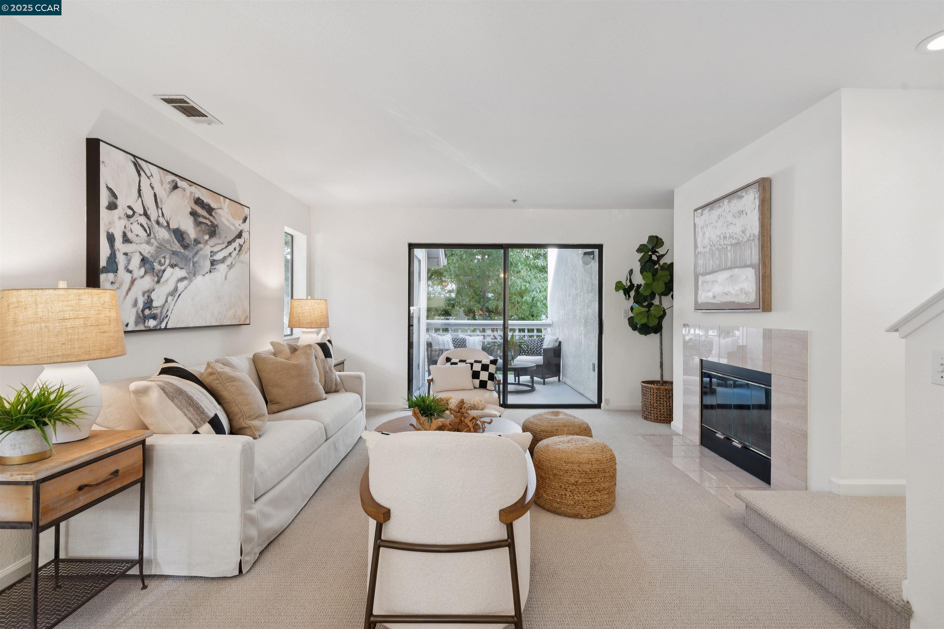 2578 Oak Road, Unit 212 Walnut Creek, CA 94597 - Photo 1 of 27 a living room with furniture and a fireplace