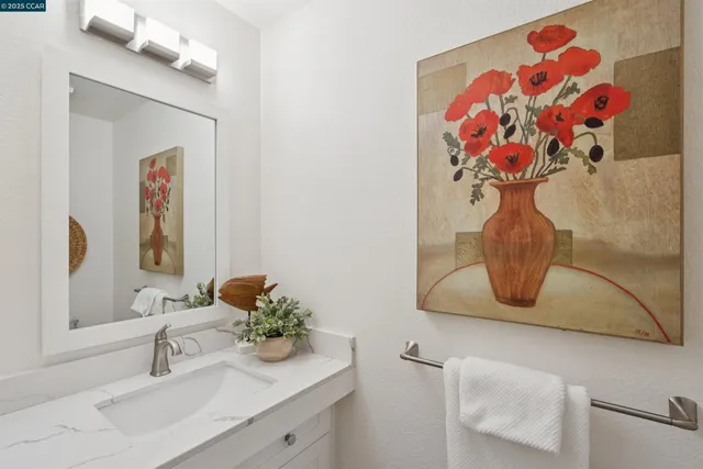 a bathroom with a sink mirror and vanity