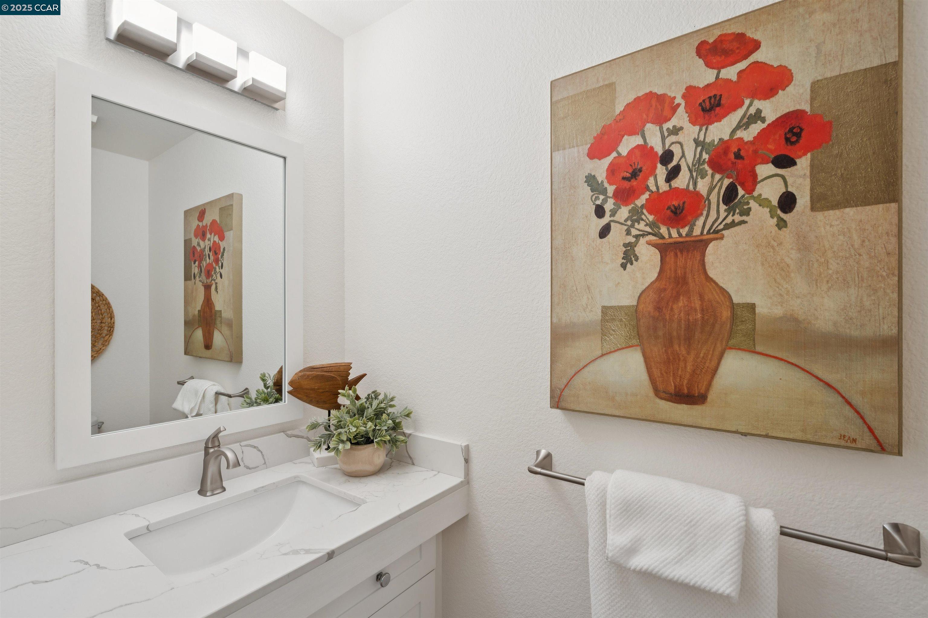 2578 Oak Road, Unit 212 Walnut Creek, CA 94597 - Photo 11 of 27 a bathroom with a sink mirror and vanity
